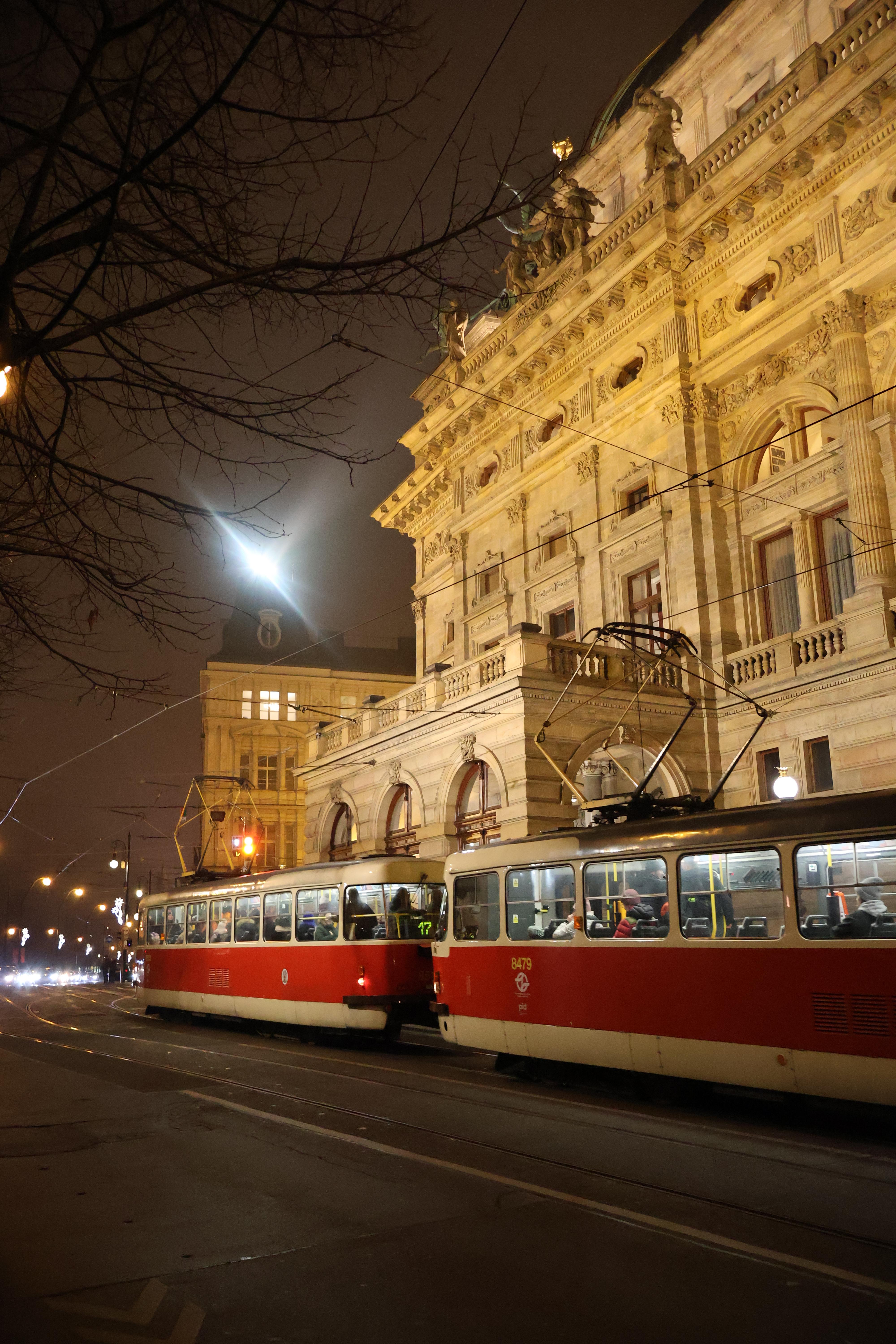 An aging tram as it zooms past the national theater.
