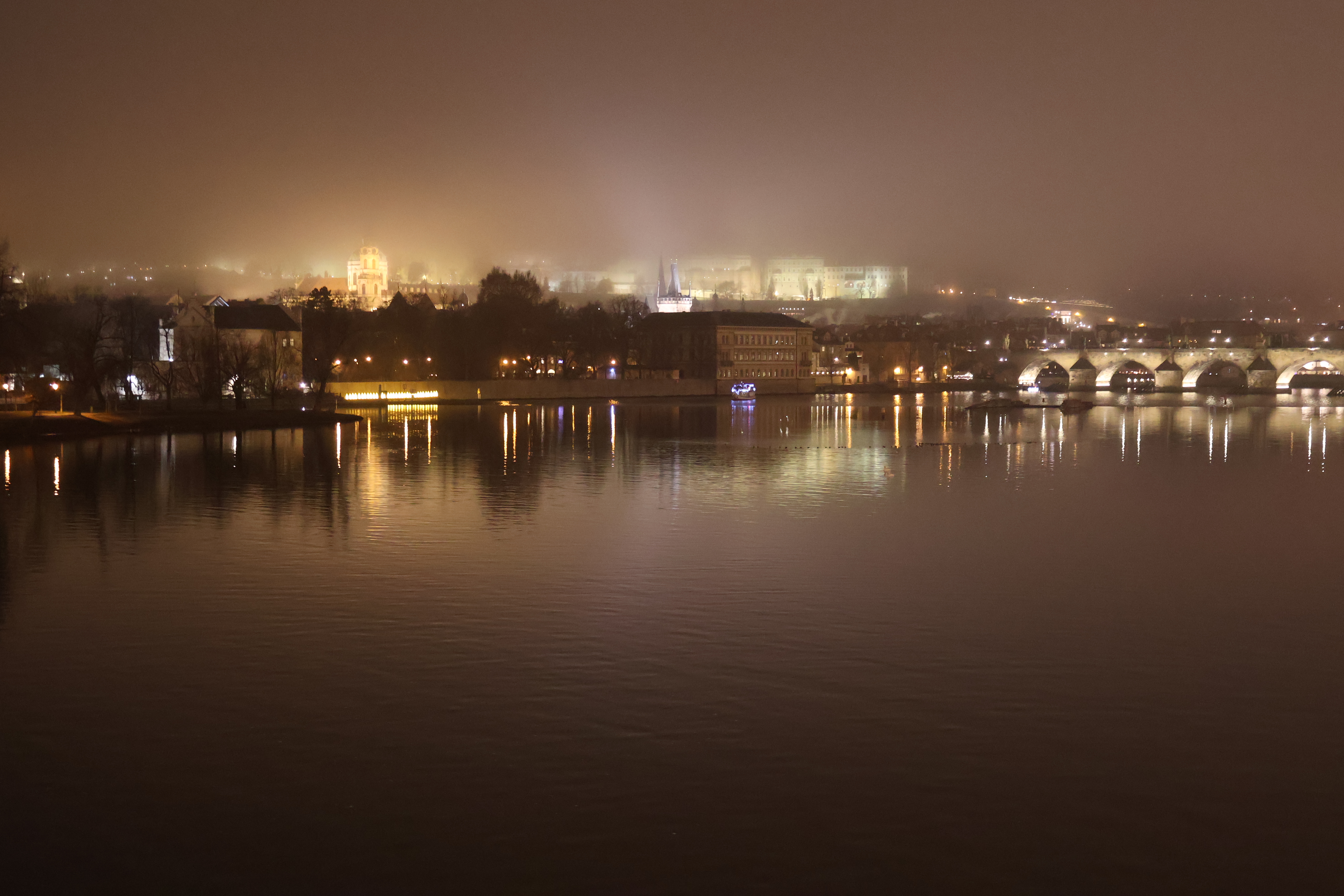 A view of the castle skyline on a foggy night.
