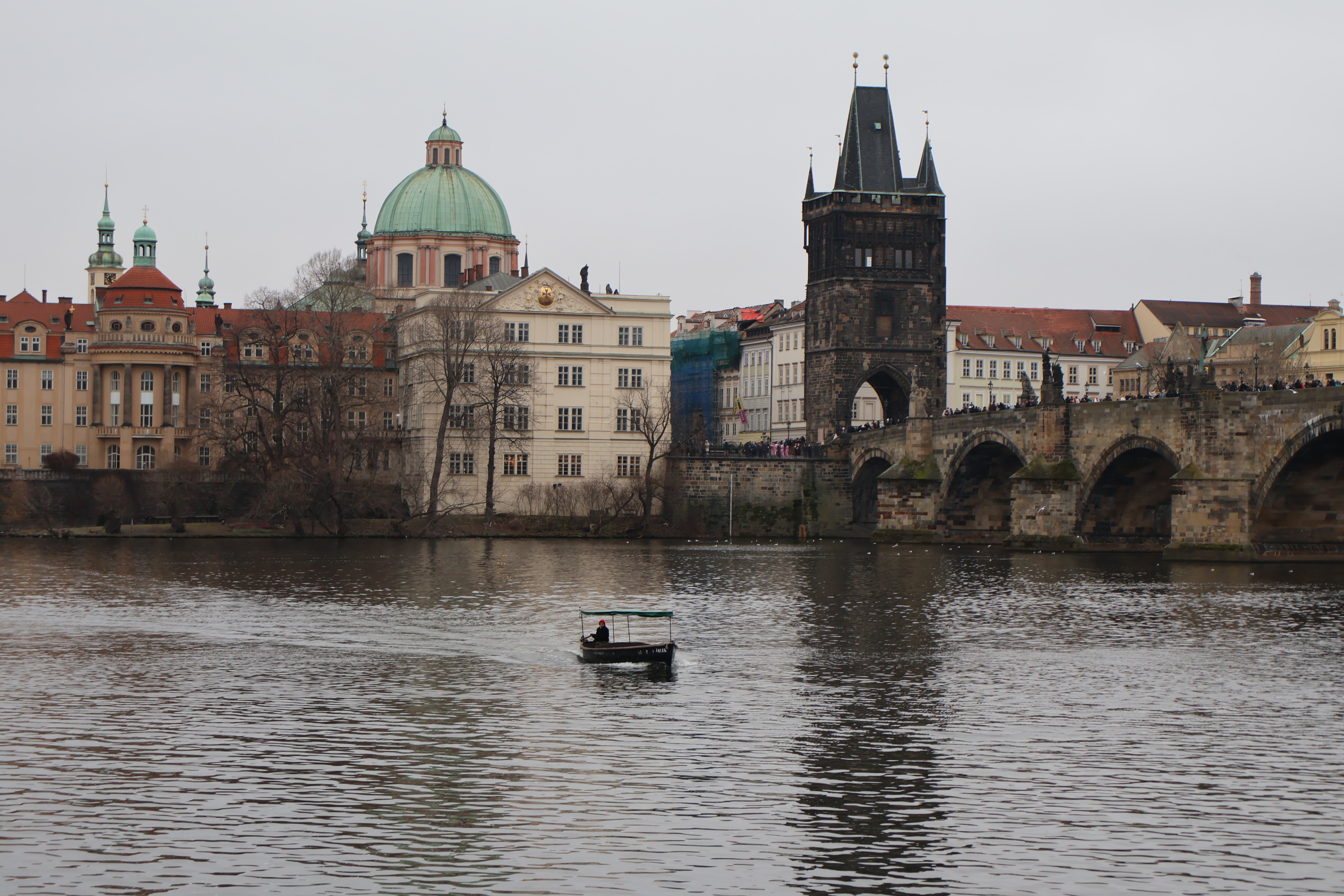 A little boat making it across by the Charles Bridge